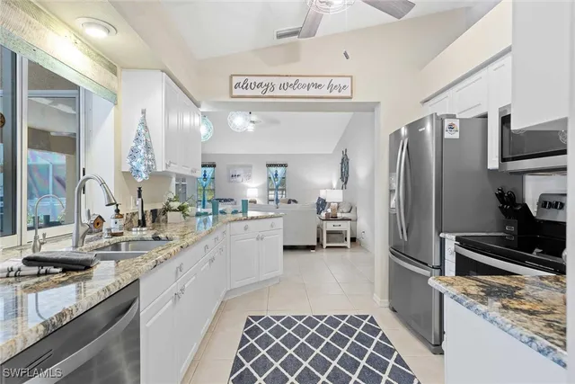 a kitchen with a sink cabinets and stainless steel appliances
