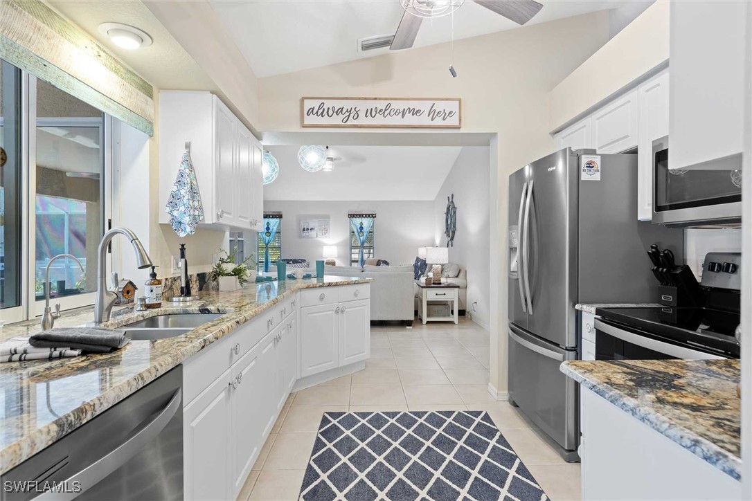 4810 Southwest 25th Place Cape Coral, FL 33914 - Photo 6 of 29 a kitchen with a sink cabinets and stainless steel appliances