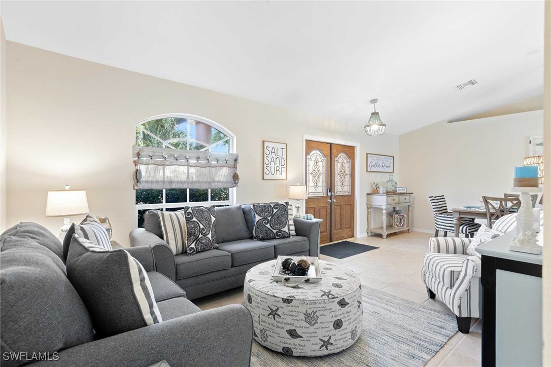 4810 Southwest 25th Place Cape Coral, FL 33914 - Photo 8 of 29 a living room with furniture and a large window