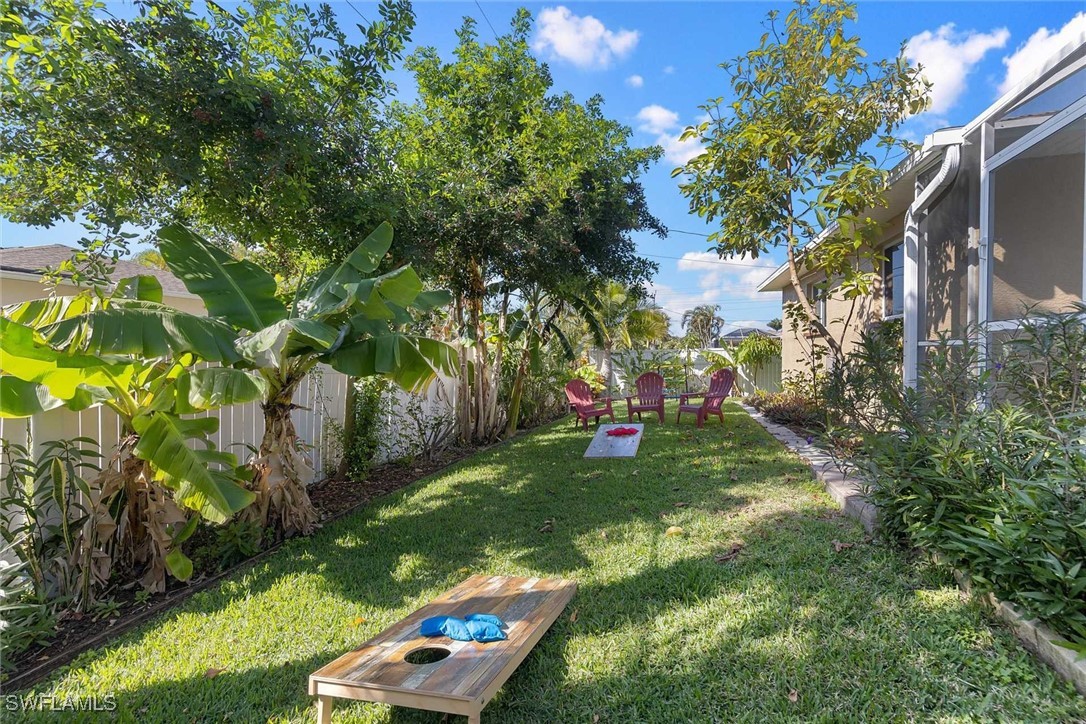 4810 Southwest 25th Place Cape Coral, FL 33914 - Photo 9 of 29 a view of a backyard with table and chairs and potted plants