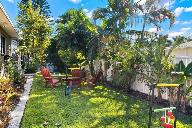 a backyard of a house with table and chairs