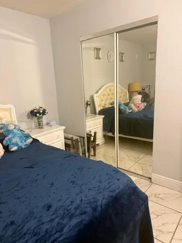 a bedroom with a bed and a mirror