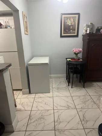 a living room with a wooden floor and a table