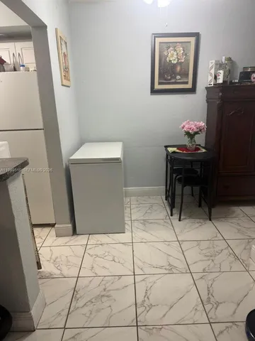 a living room with a wooden floor and a table