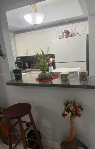 a table with a vase and flowers on it