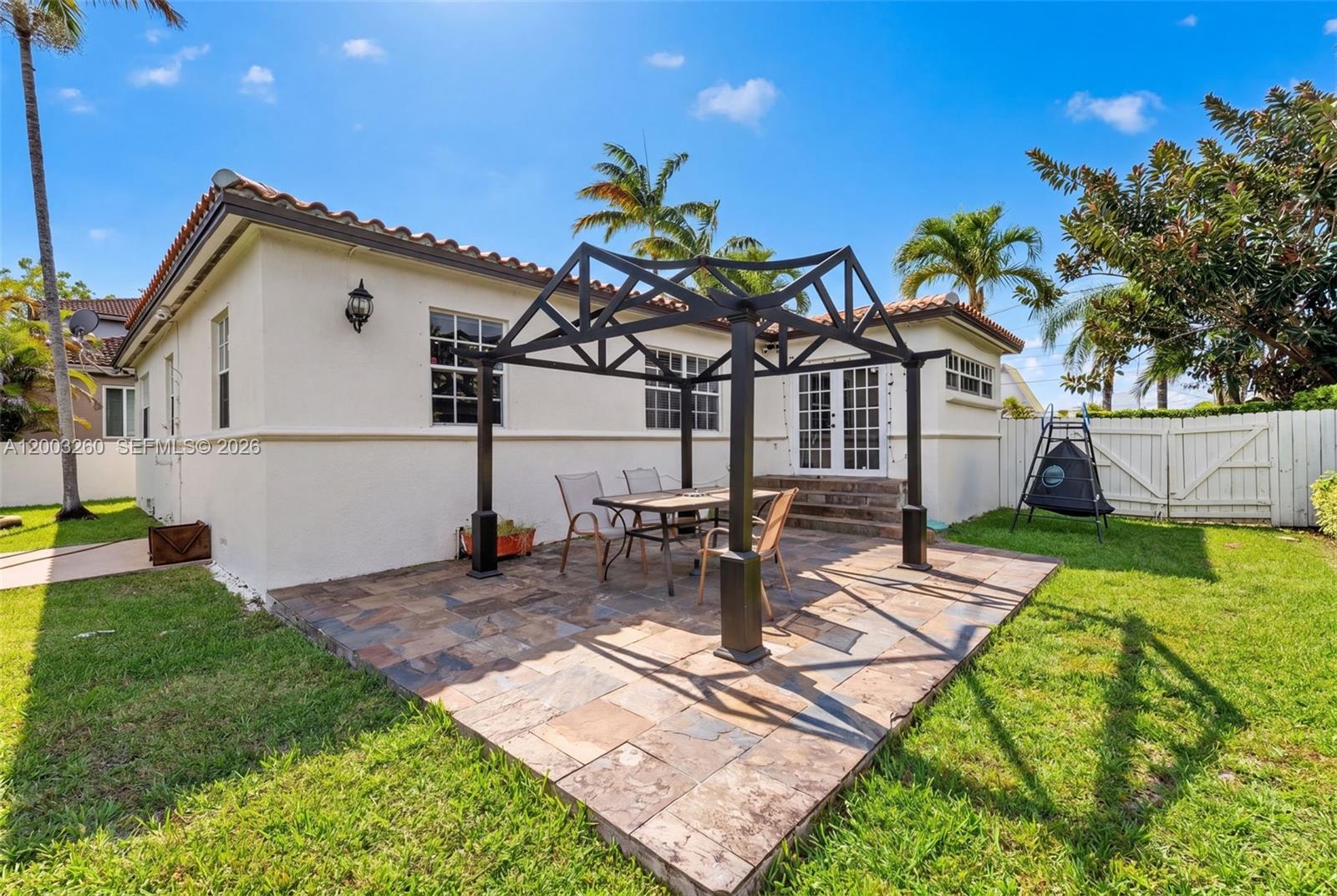 9000 Southwest 40th Terrace Miami, FL 33165 - Photo 15 of 23 a view of a house with backyard sitting area and garden
