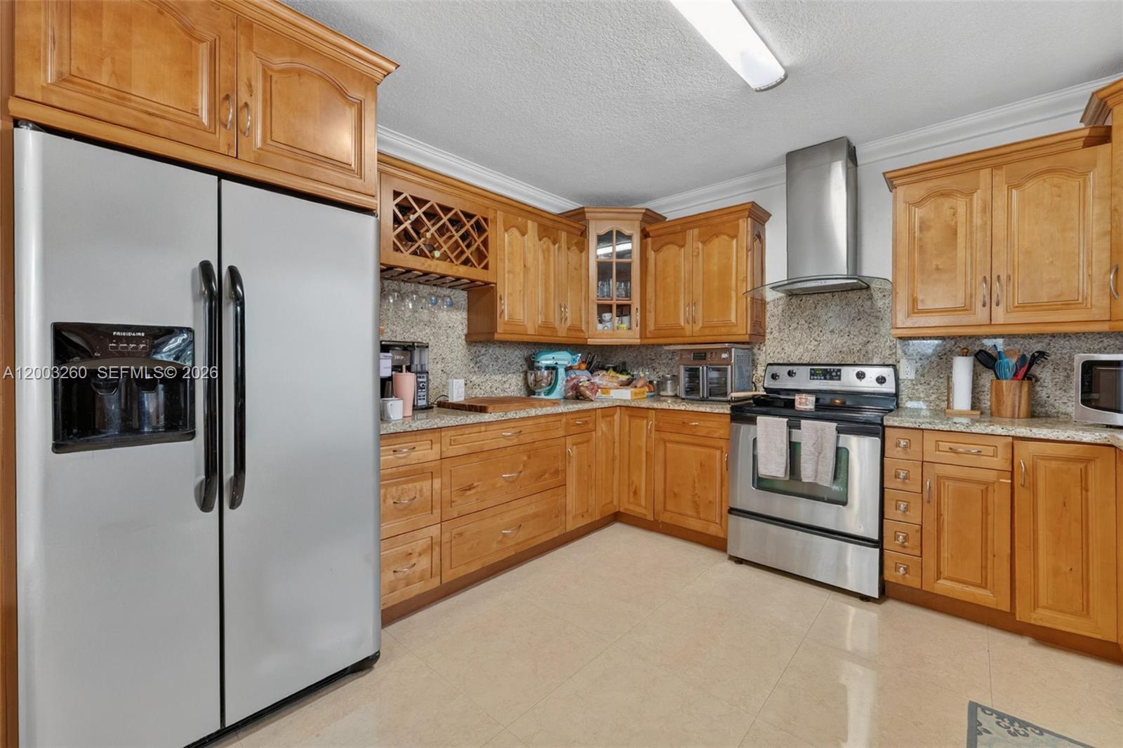 9000 Southwest 40th Terrace Miami, FL 33165 - Photo 4 of 23 a kitchen with stainless steel appliances granite countertop a refrigerator sink stove microwave and cabinets