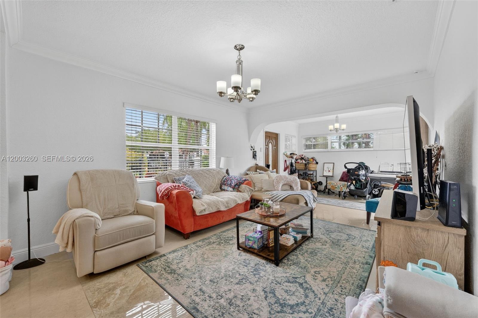9000 Southwest 40th Terrace Miami, FL 33165 - Photo 7 of 23 a living room with furniture and a chandelier