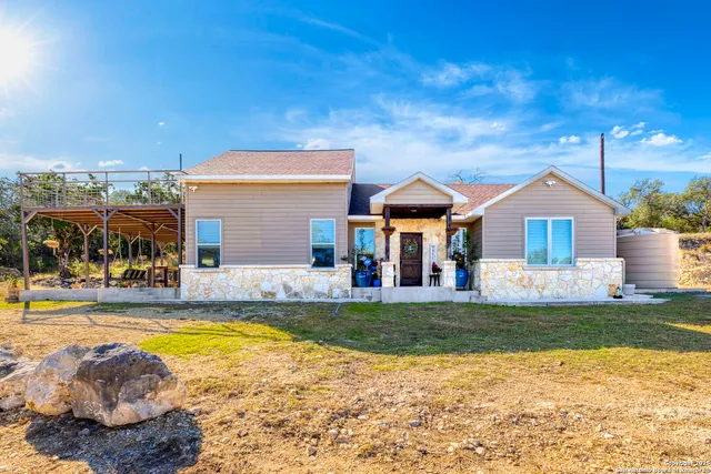 a view of a house with swimming pool and a yard