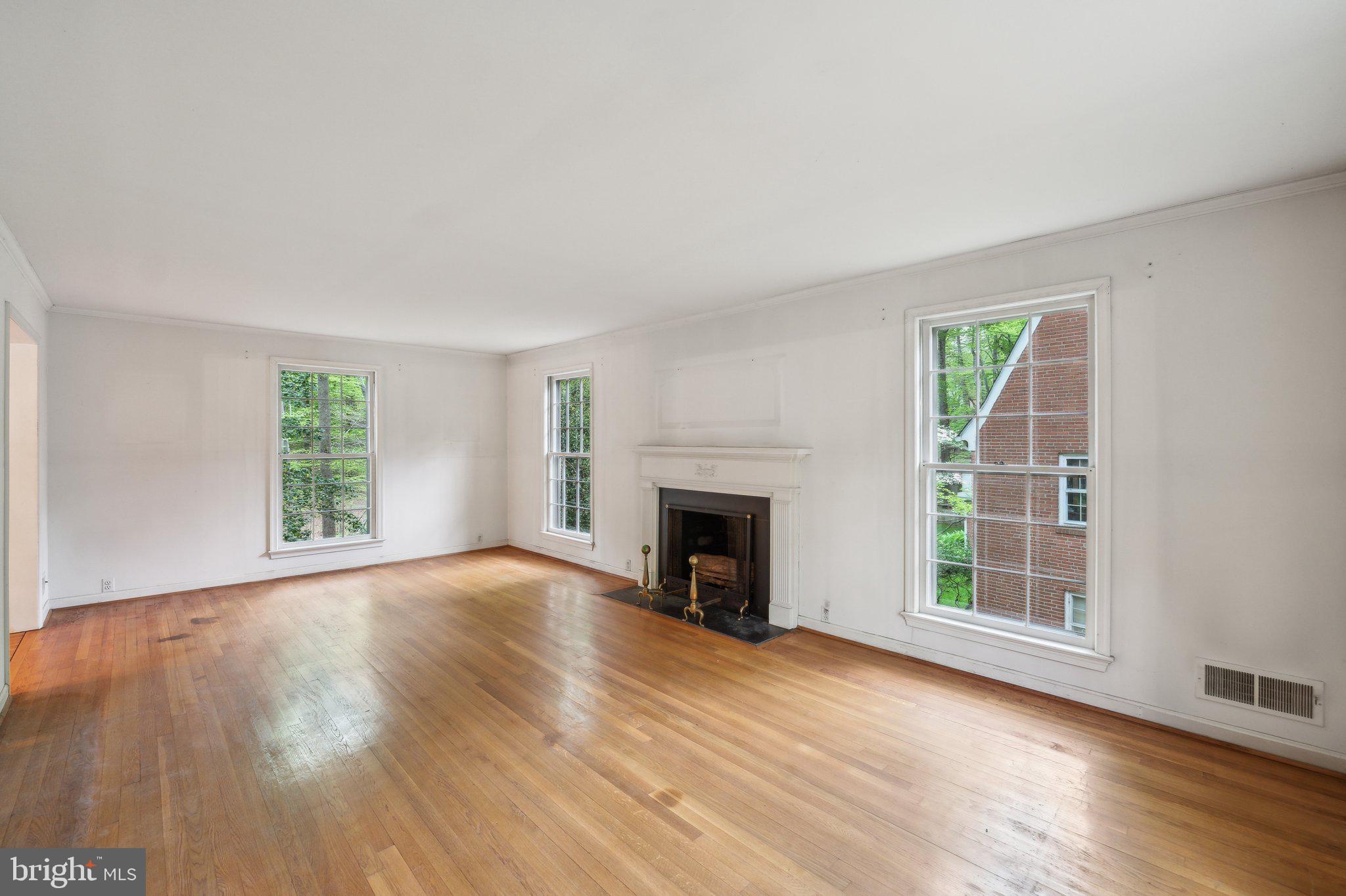 7604 Hackamore Drive Potomac, MD 20854 - Photo 12 of 56 a view of an empty room with wooden floor fireplace and a window