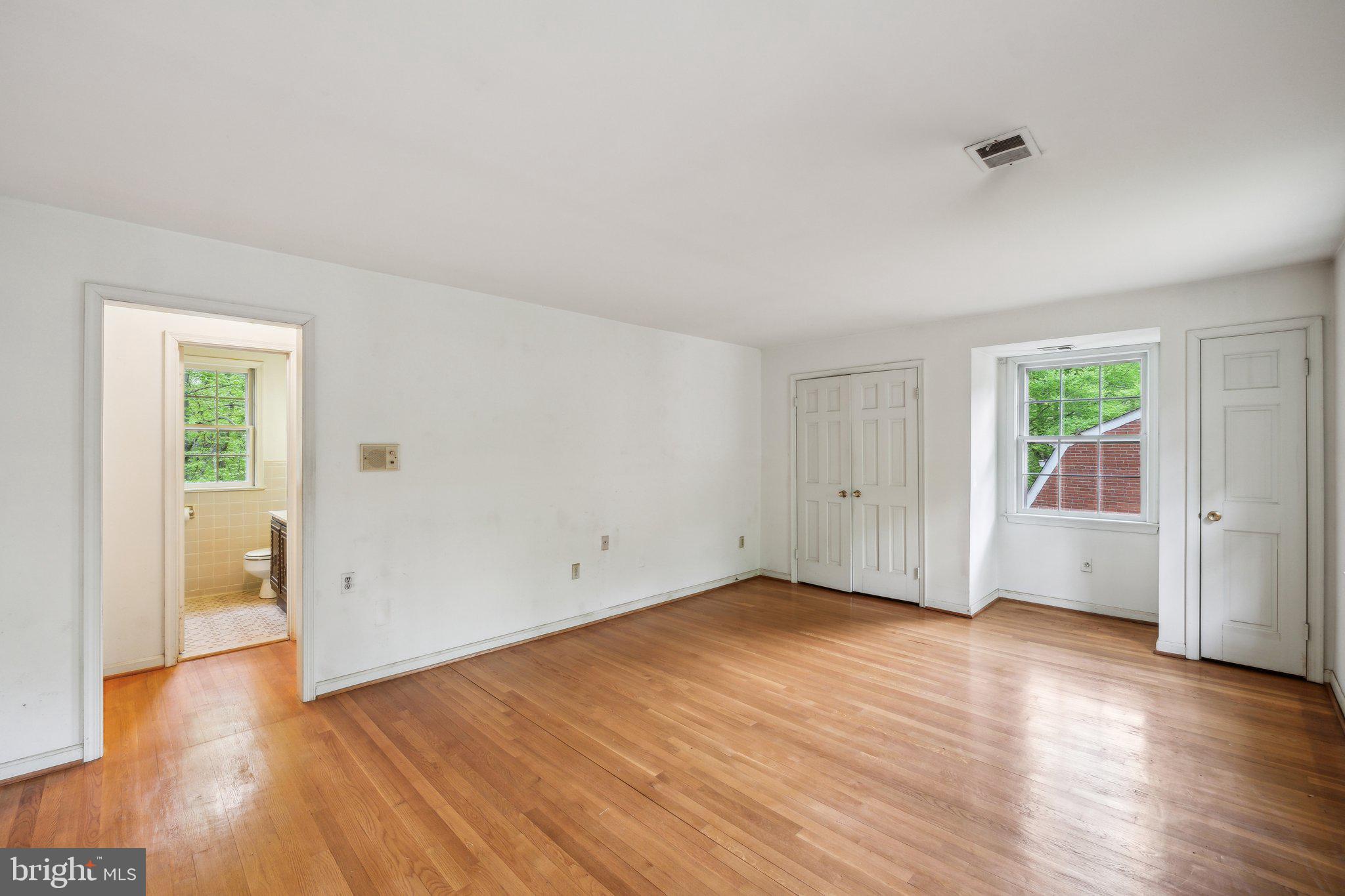 7604 Hackamore Drive Potomac, MD 20854 - Photo 15 of 56 an empty room with wooden floor and windows