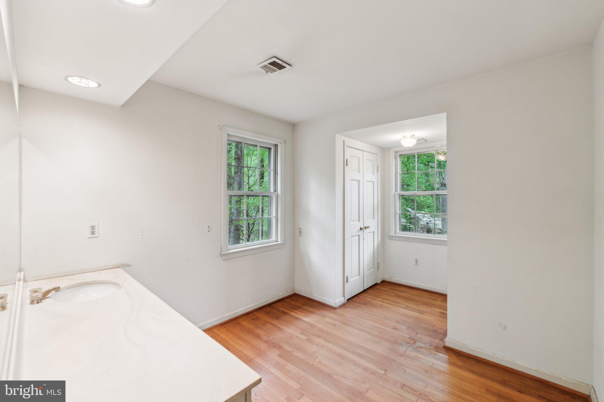 7604 Hackamore Drive Potomac, MD 20854 - Photo 19 of 56 an empty room with wooden floor and windows