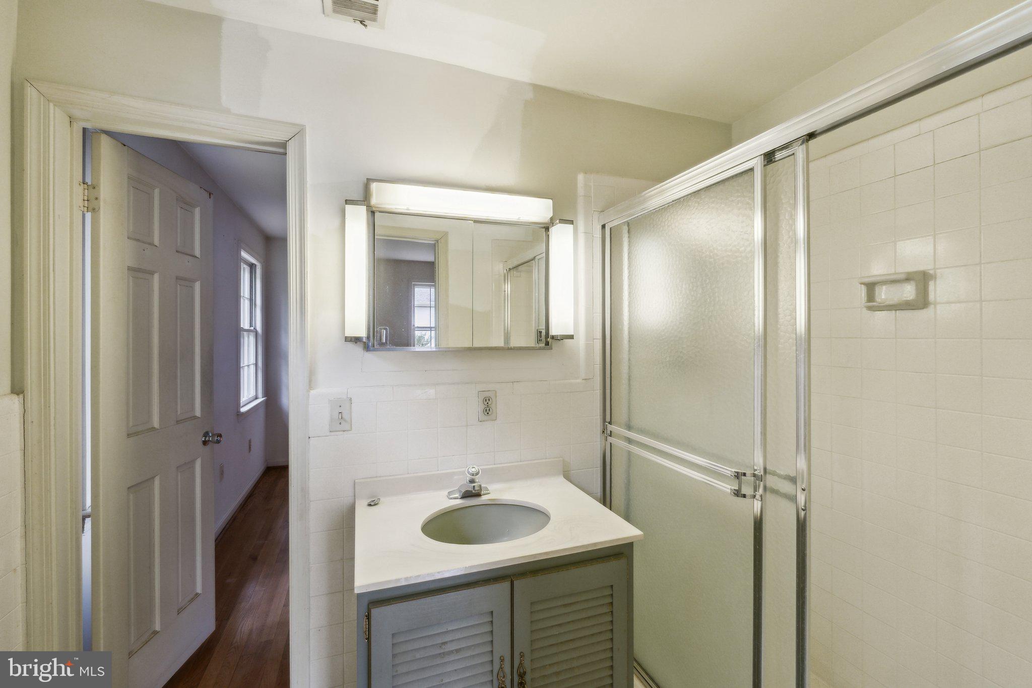 7604 Hackamore Drive Potomac, MD 20854 - Photo 22 of 56 a bathroom with a sink and a mirror