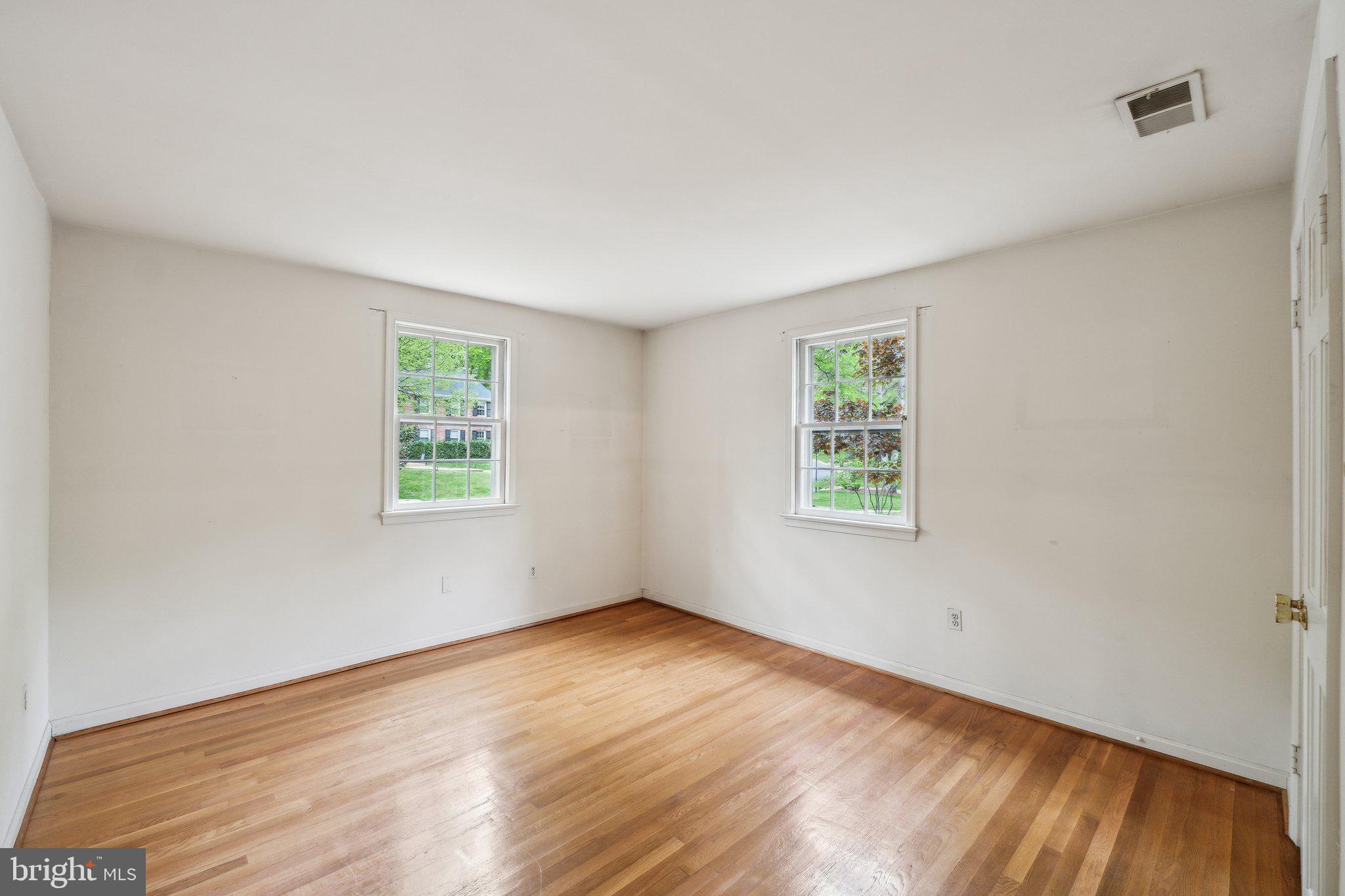 7604 Hackamore Drive Potomac, MD 20854 - Photo 25 of 56 a view of an empty room with wooden floor and a window