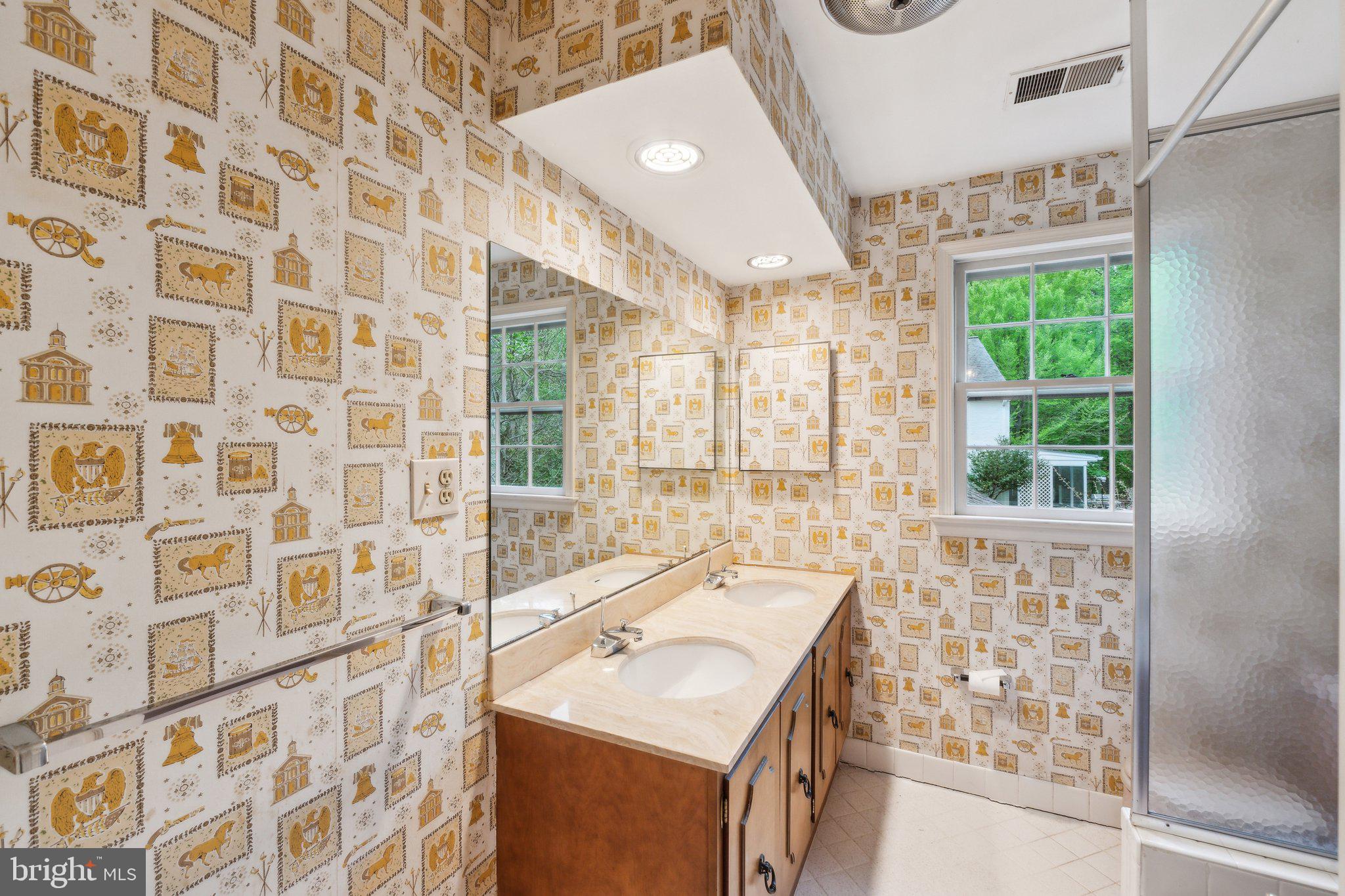 7604 Hackamore Drive Potomac, MD 20854 - Photo 27 of 56 a bathroom with a sink a large mirror and a shower