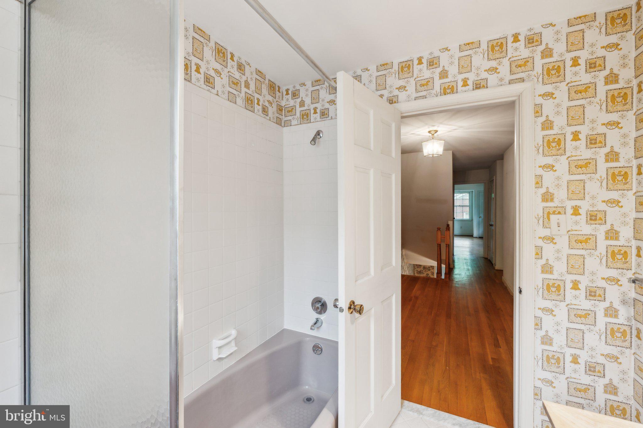 7604 Hackamore Drive Potomac, MD 20854 - Photo 28 of 56 a bathroom with a glass shower door