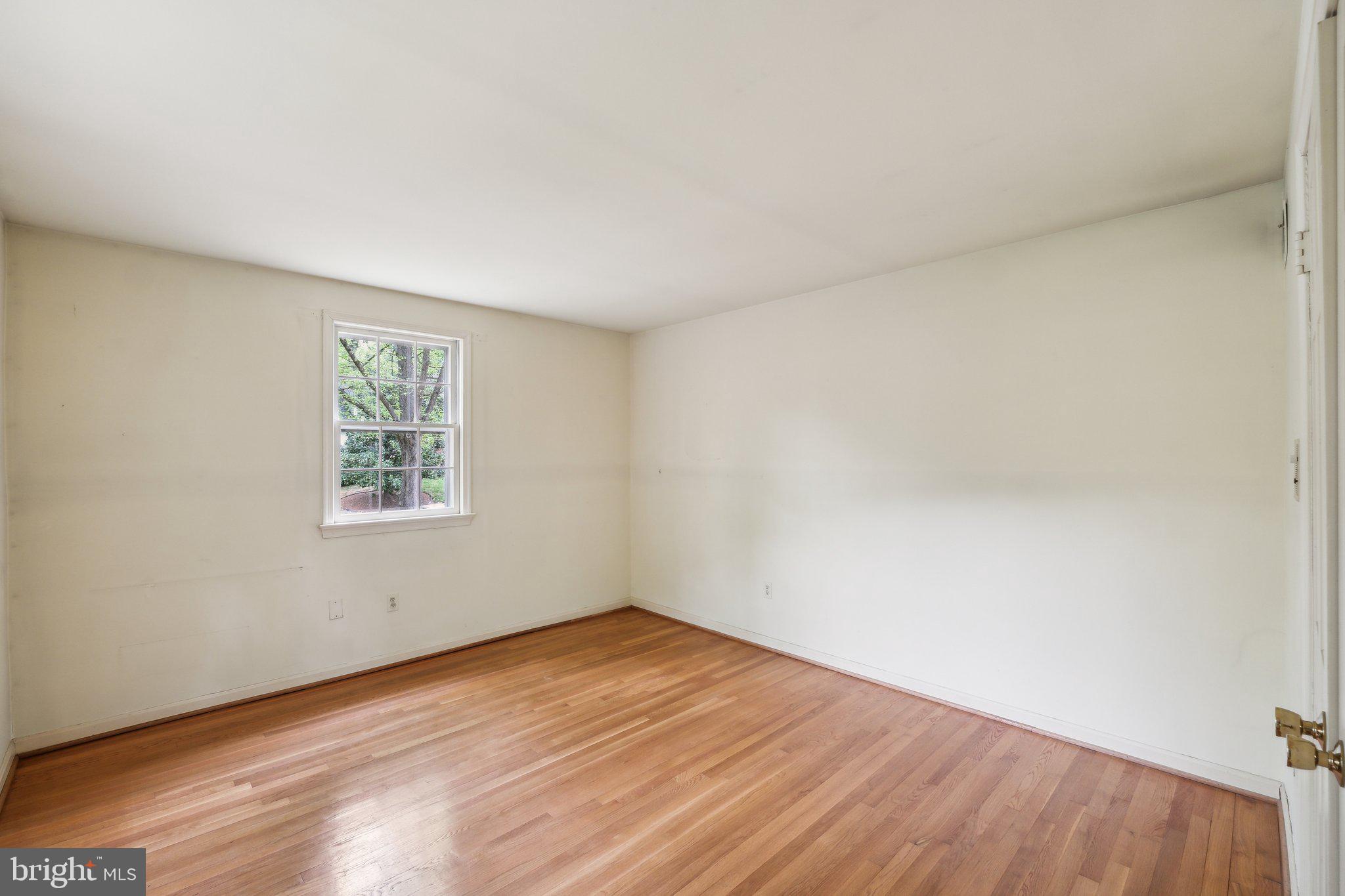 7604 Hackamore Drive Potomac, MD 20854 - Photo 30 of 56 an empty room with wooden floor and windows