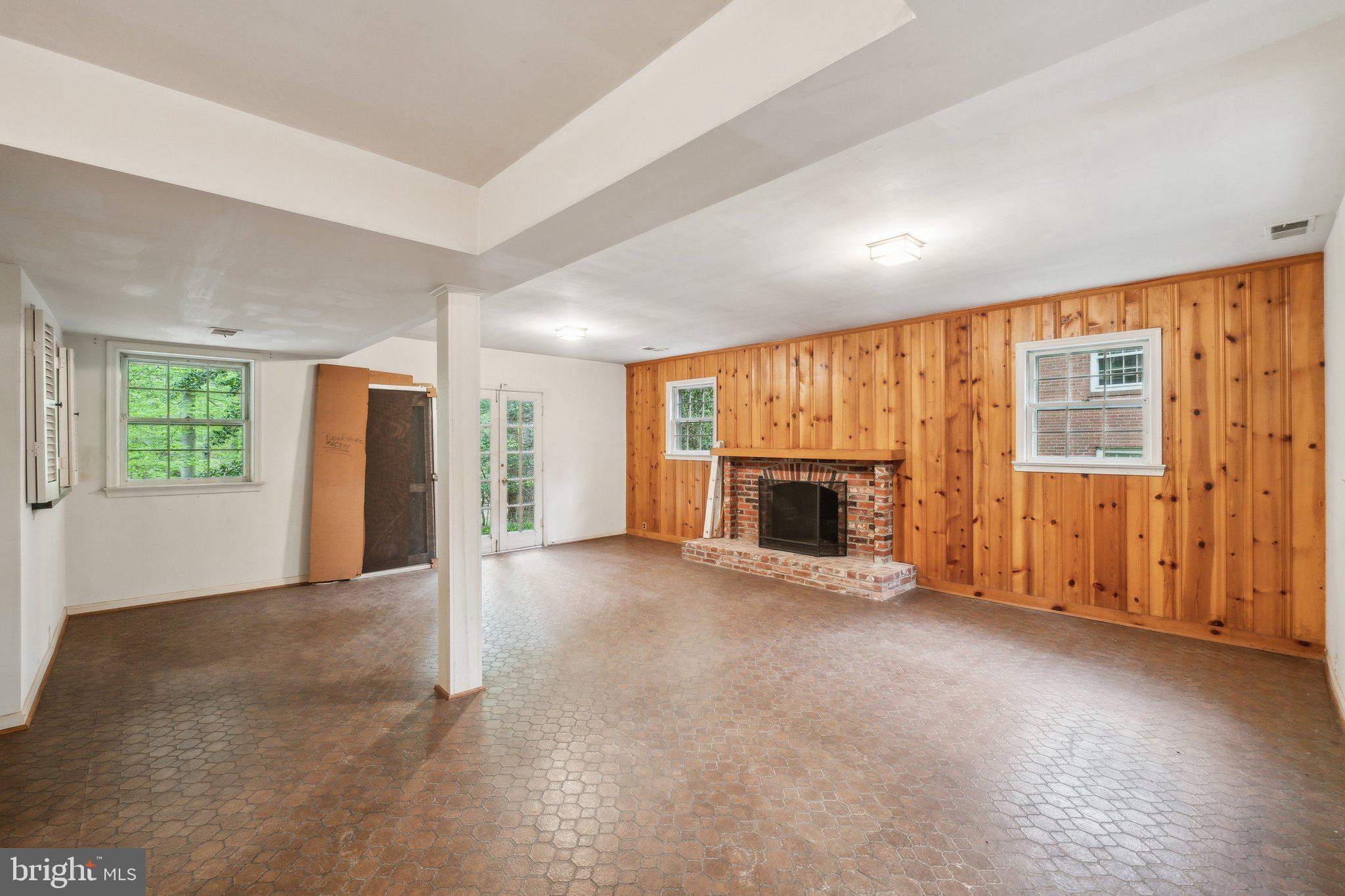 7604 Hackamore Drive Potomac, MD 20854 - Photo 31 of 56 an empty room with windows fireplace and windows