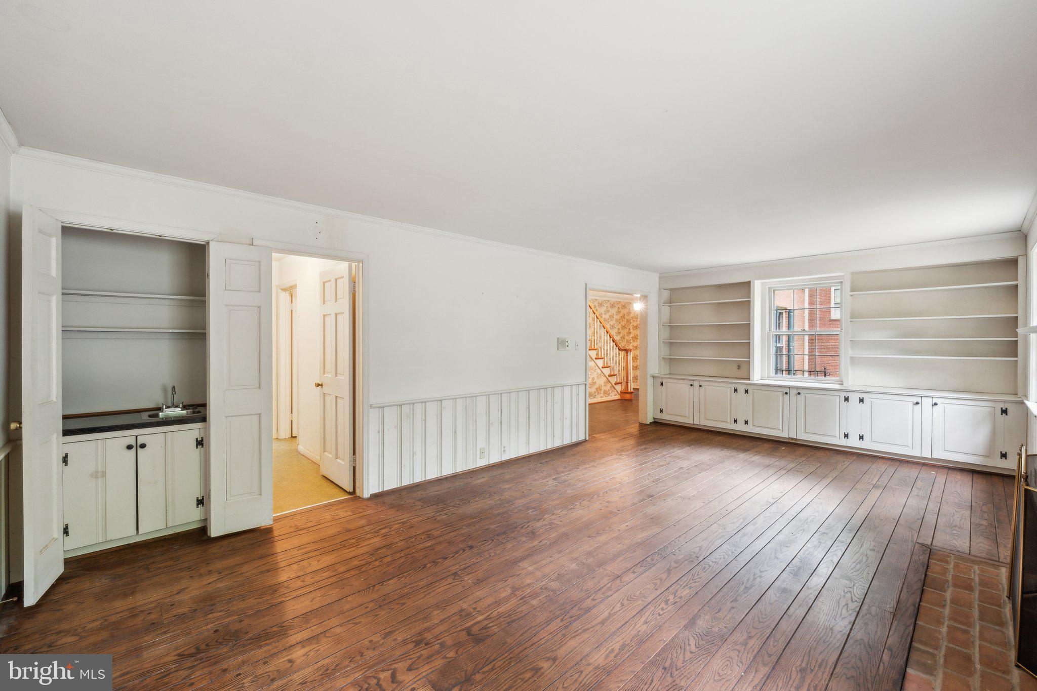 7604 Hackamore Drive Potomac, MD 20854 - Photo 4 of 56 an empty room with wooden floor and cabinet