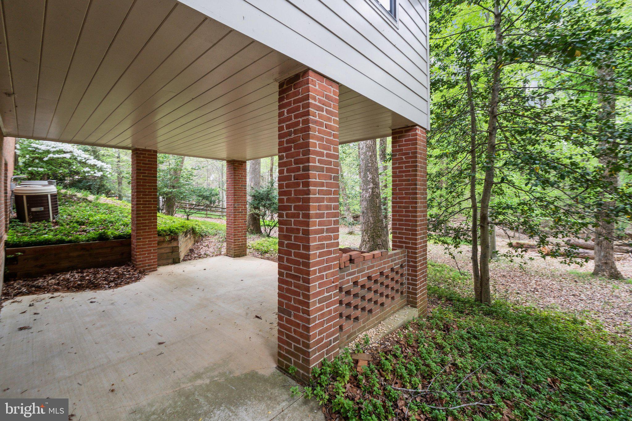 7604 Hackamore Drive Potomac, MD 20854 - Photo 44 of 56 a front view of a house with a garden