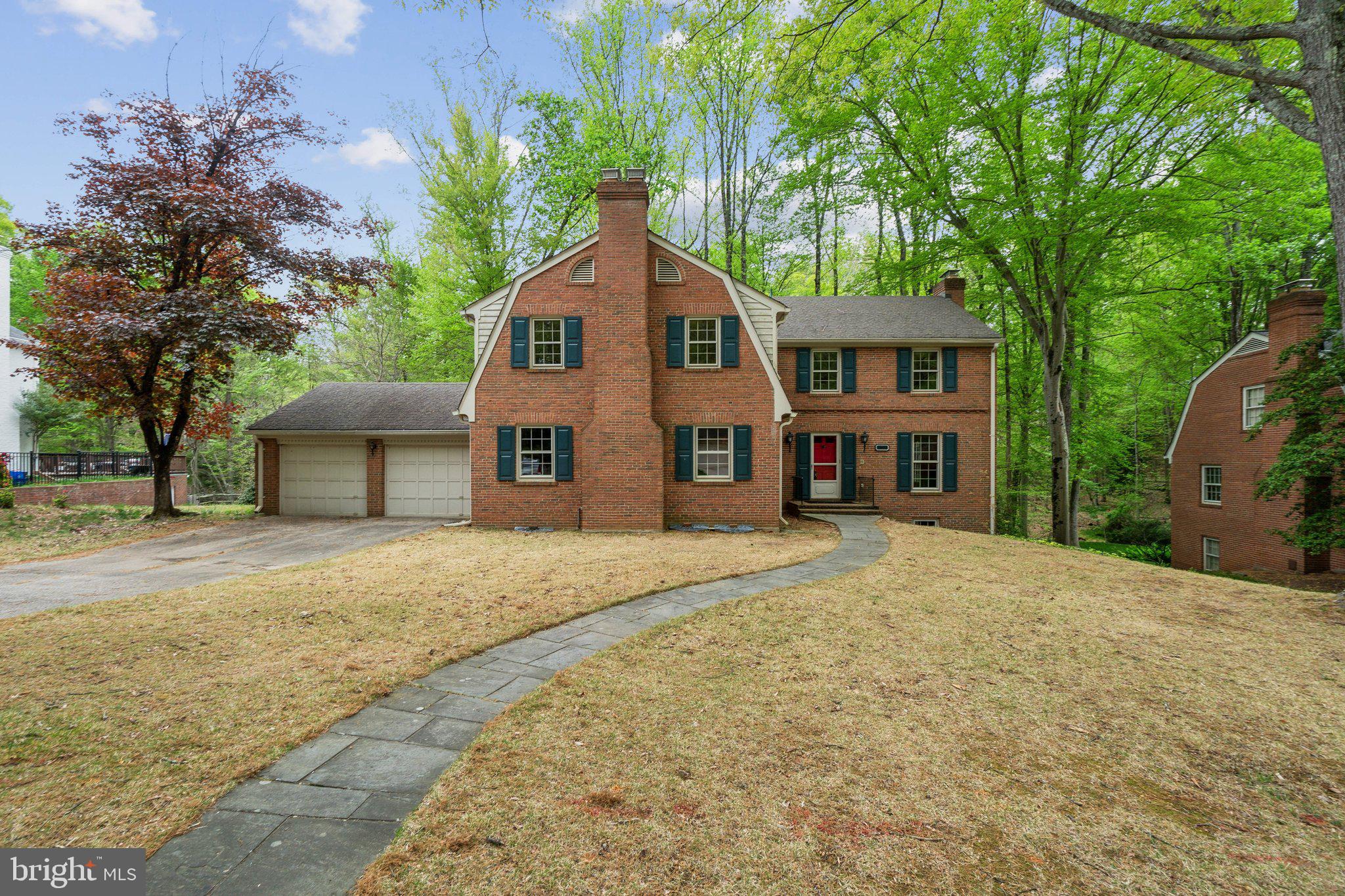 7604 Hackamore Drive Potomac, MD 20854 - Photo 45 of 56 a front view of a house with a yard and garage