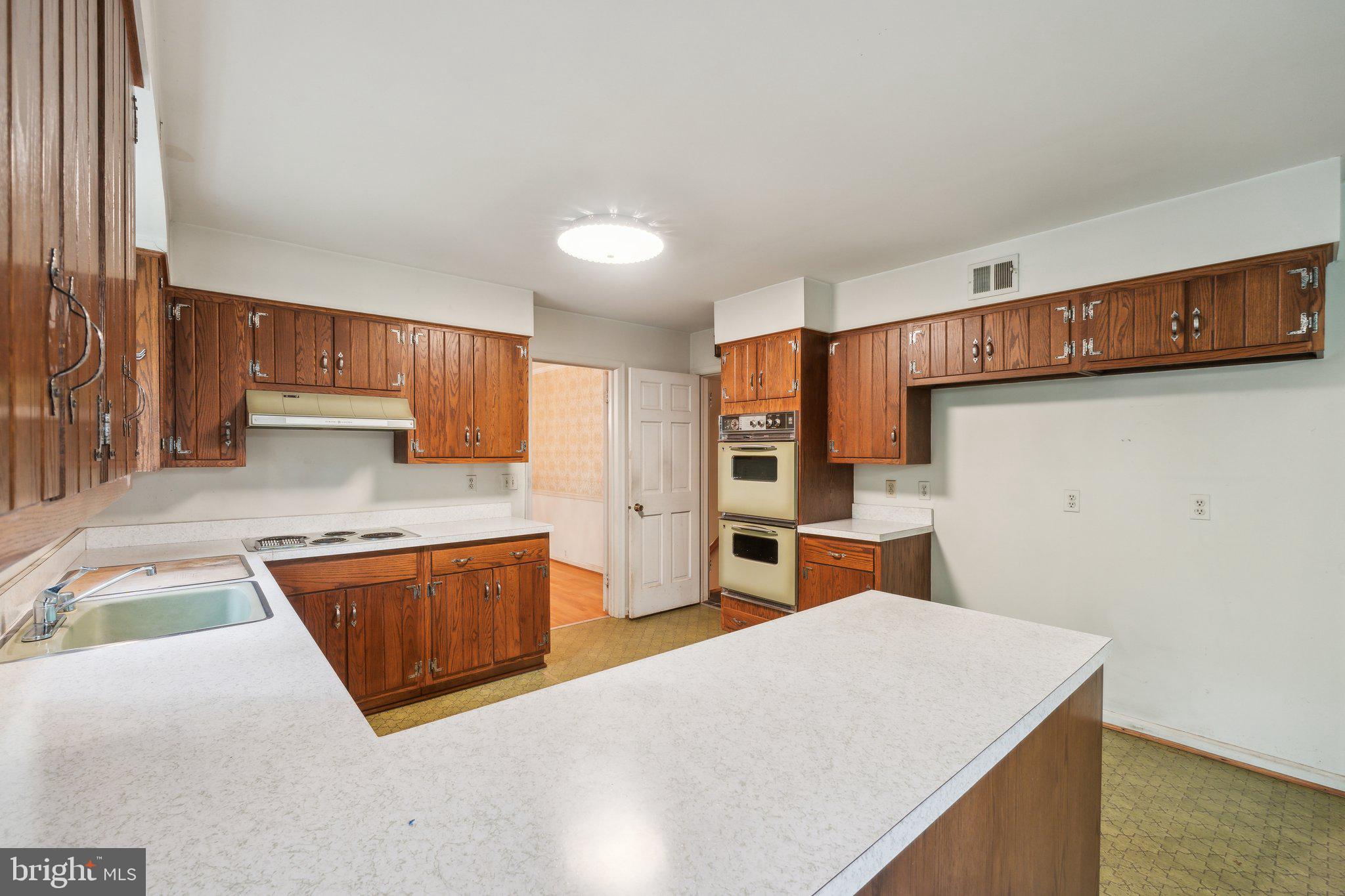 7604 Hackamore Drive Potomac, MD 20854 - Photo 48 of 56 a kitchen with stainless steel appliances granite countertop a refrigerator and a sink