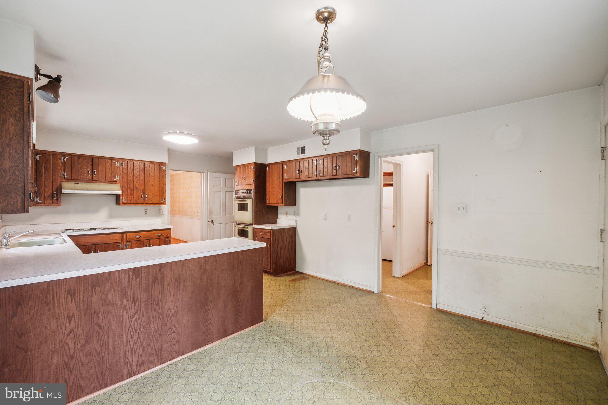 7604 Hackamore Drive Potomac, MD 20854 - Photo 50 of 56 a view of a kitchen with furniture and a ceiling fan