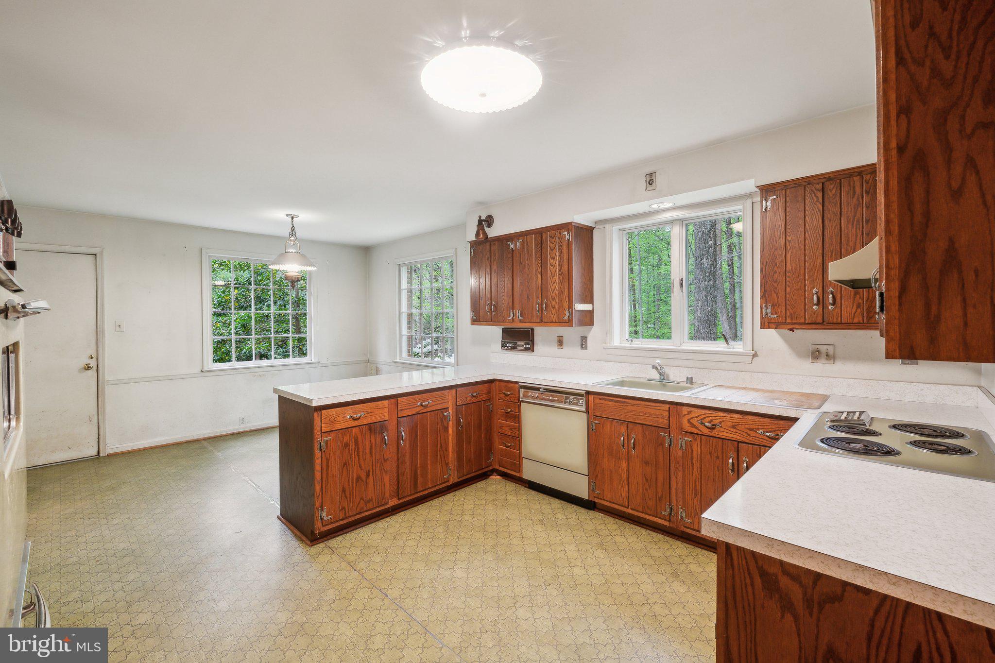 7604 Hackamore Drive Potomac, MD 20854 - Photo 5 of 56 a kitchen with stainless steel appliances granite countertop a stove a sink and a refrigerator