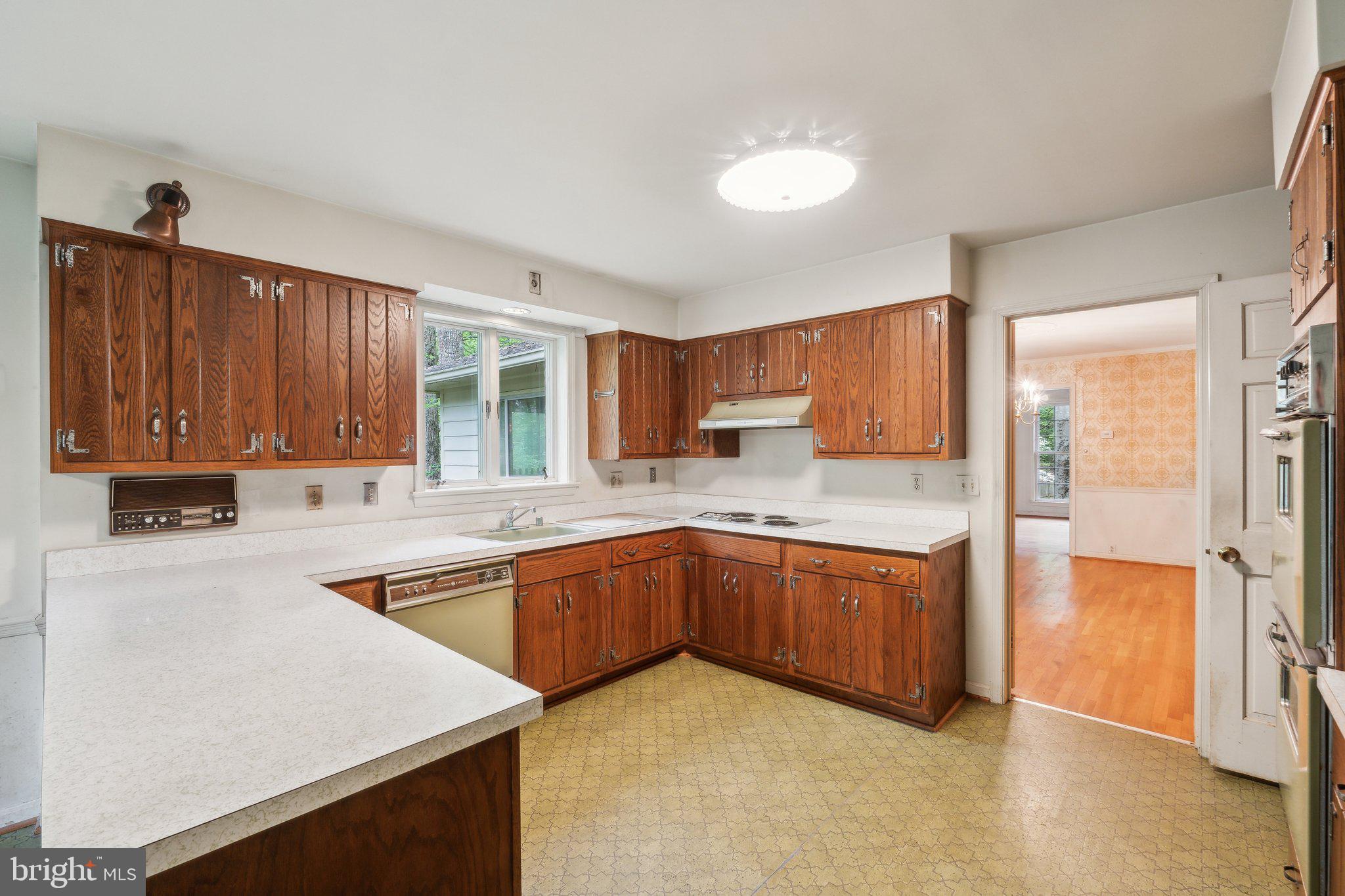 7604 Hackamore Drive Potomac, MD 20854 - Photo 51 of 56 a kitchen with stainless steel appliances granite countertop a stove a sink and a refrigerator