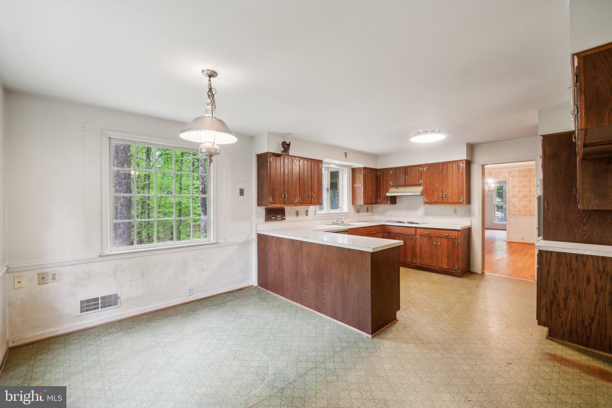 7604 Hackamore Drive Potomac, MD 20854 - Photo 7 of 56 a large kitchen with granite countertop a large counter top appliances and cabinets