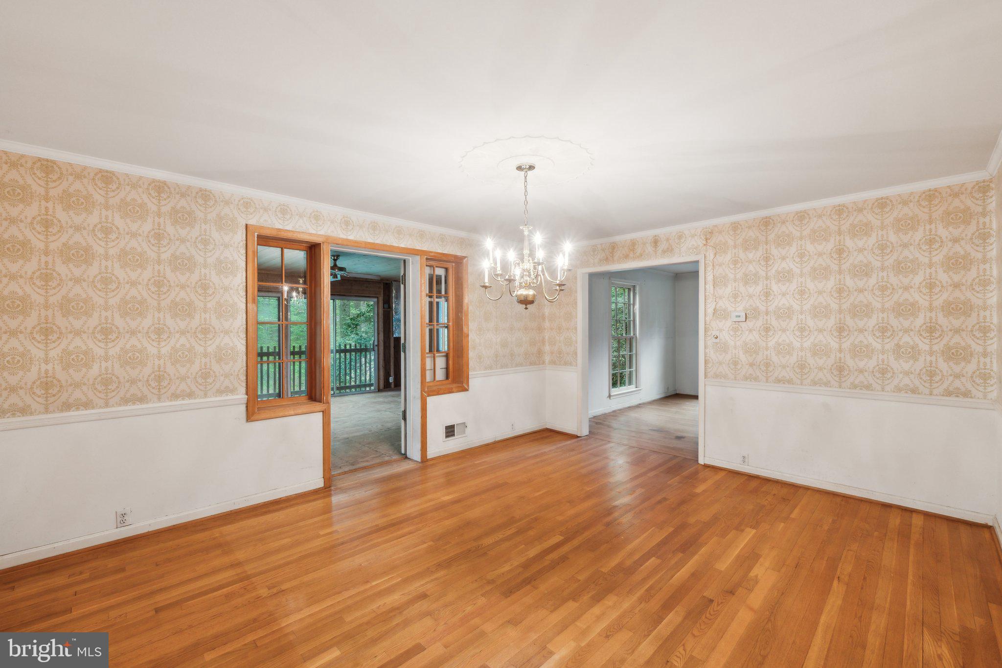 7604 Hackamore Drive Potomac, MD 20854 - Photo 8 of 56 a view of an empty room with wooden floor and a window