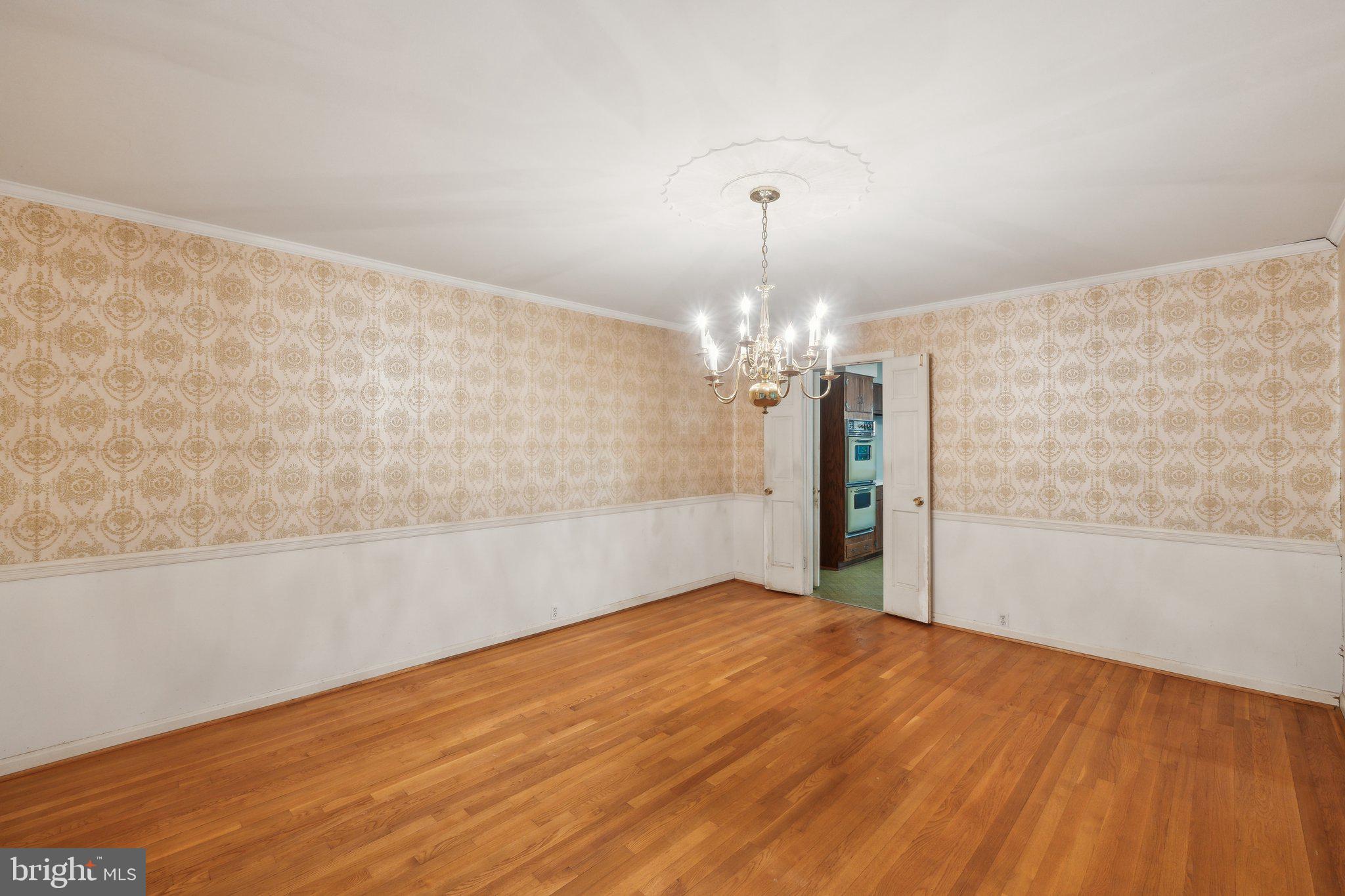 7604 Hackamore Drive Potomac, MD 20854 - Photo 9 of 56 a view of a big room with wooden floor and chandelier
