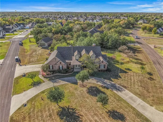 an aerial view of a house with a yard