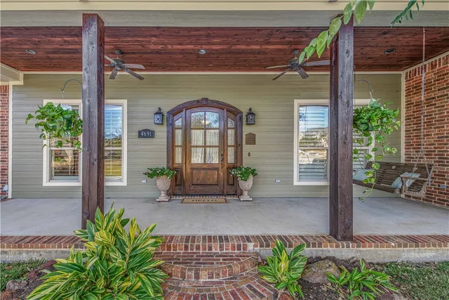 a front view of a house with outdoor seating and a garden