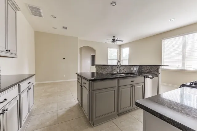 a kitchen with a sink stove and cabinets