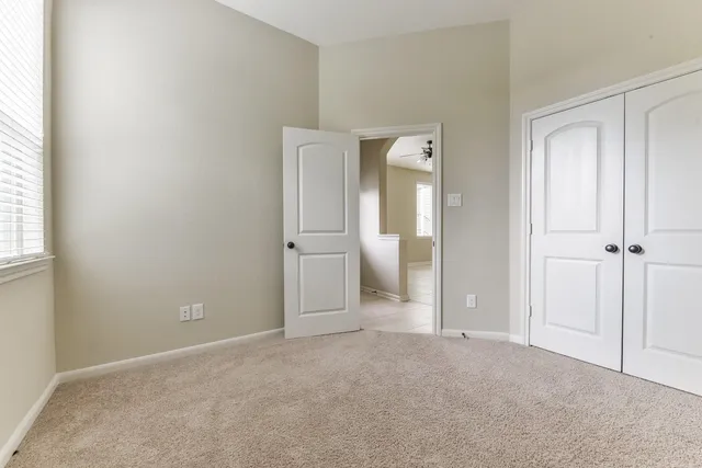 an empty room with an entryway and a bathroom