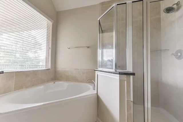 a white bath tub sitting next to a window