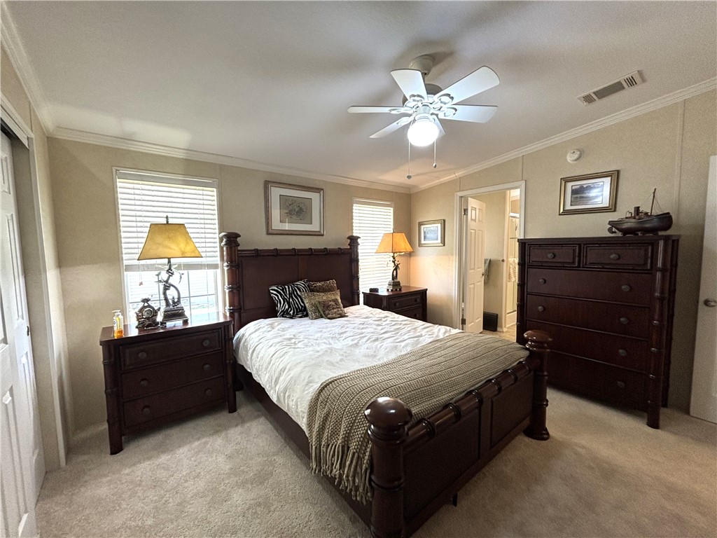 6171 98th Road Sebastian, FL 32958 - Photo 11 of 14 a bedroom with a bed and a chandelier