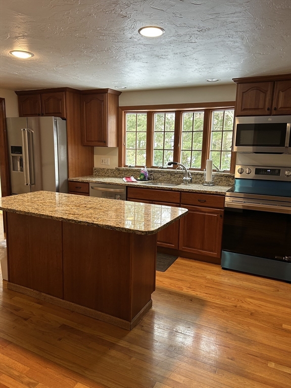200 Plympton Road, Unit 200 Plymouth, MA 02360 - Photo 3 of 10 a large kitchen with wooden cabinets and a sink