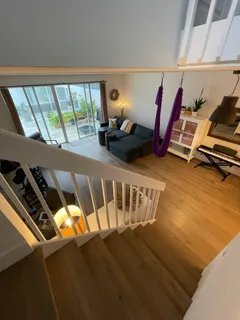 a view of a room with wooden floor and windows