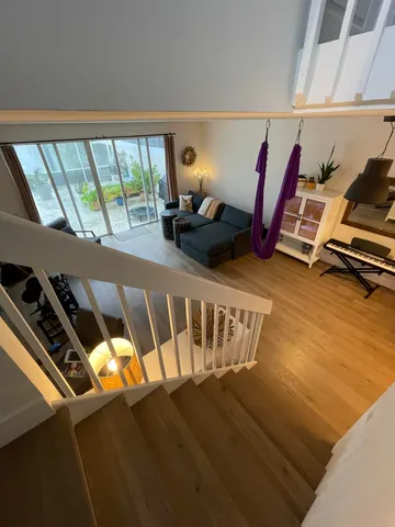 a view of a room with wooden floor and windows