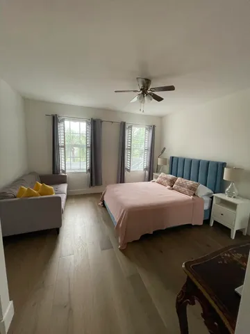 a spacious bedroom with a bed and a couch