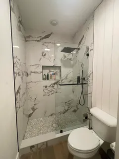 a bathroom with a toilet sink and shower