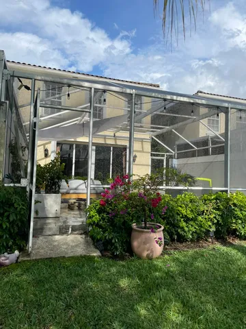 a view of a house with sitting area and garden