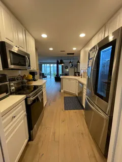 a kitchen with stainless steel appliances granite countertop wooden cabinets a stove top oven a sink and dishwasher