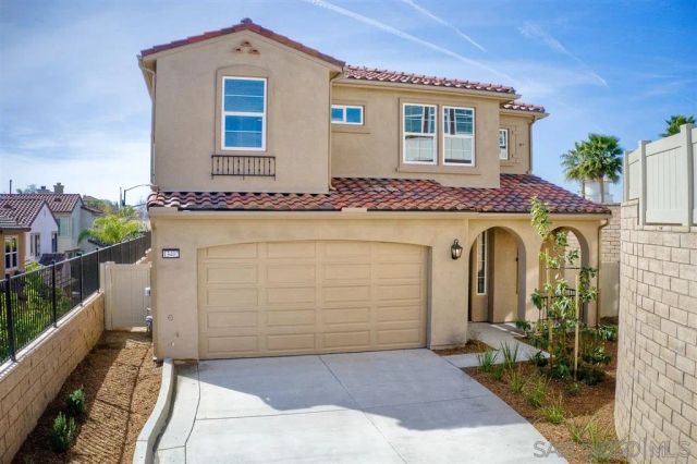 a front view of a house with trees