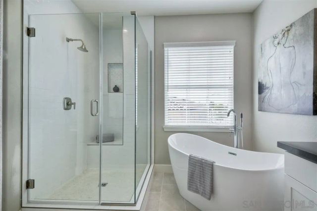 a bathroom with a bathtub and shower