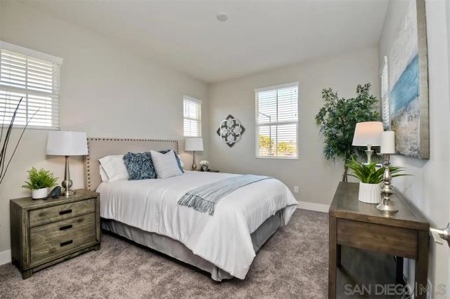 a bedroom with bed and a window