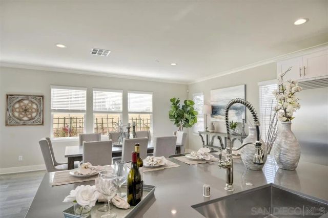 a living room with fireplace furniture and a large window