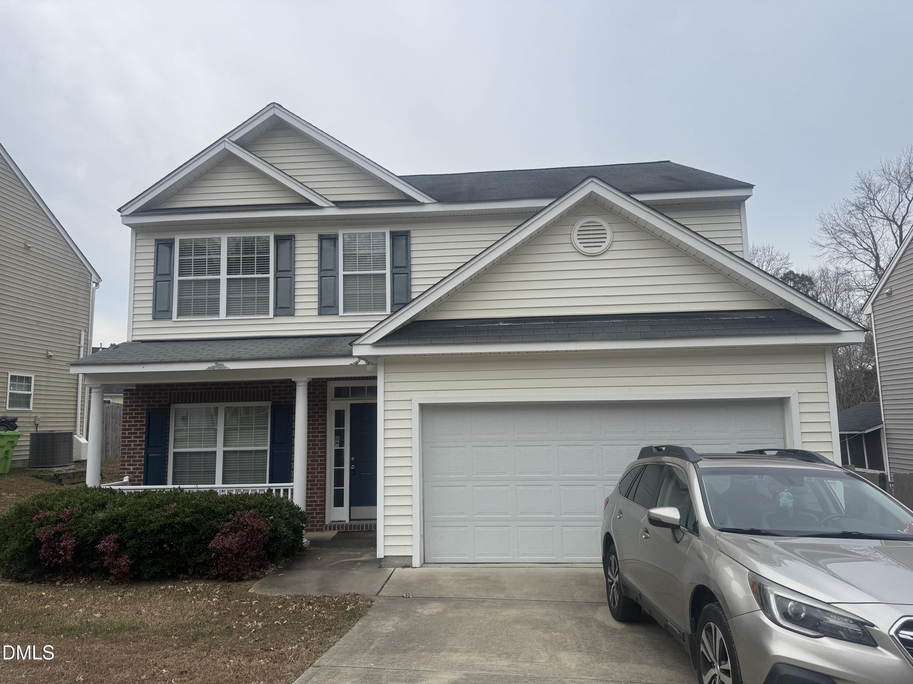 a front view of a house with garage